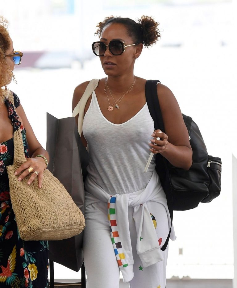Mel B braless boobs in a see through white top showing off her tits seen by paparazzi at the airport.






