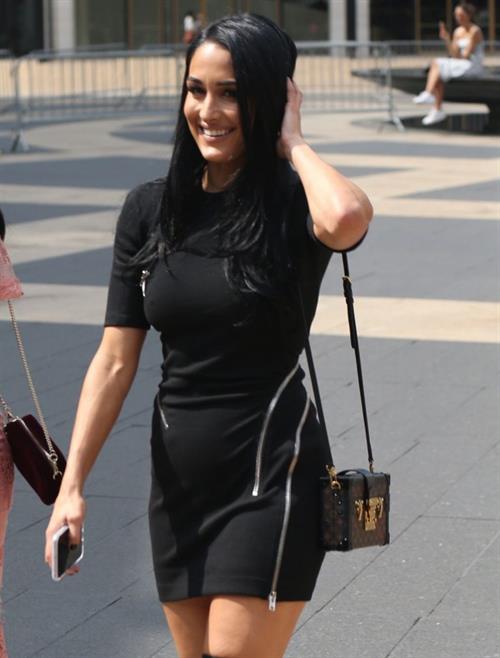 Nikki Bella Pictures Nikki Bella braless boobs pokies in a black top showing off her tits seen by paparazzi with Brie Bella showing nice cleavage.
