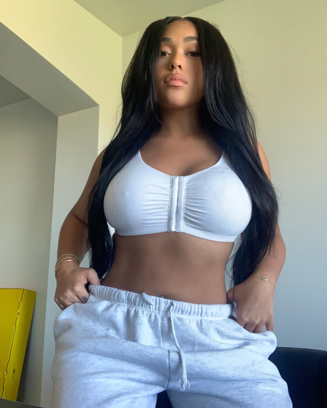 Jordyn Woods Pictures Jordyn Woods tits in a tight white little top showing off her big boobs and hard nipples.