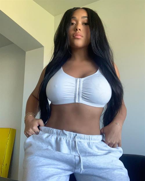 Jordyn Woods tits in a tight white little top showing off her big boobs and hard nipples.
