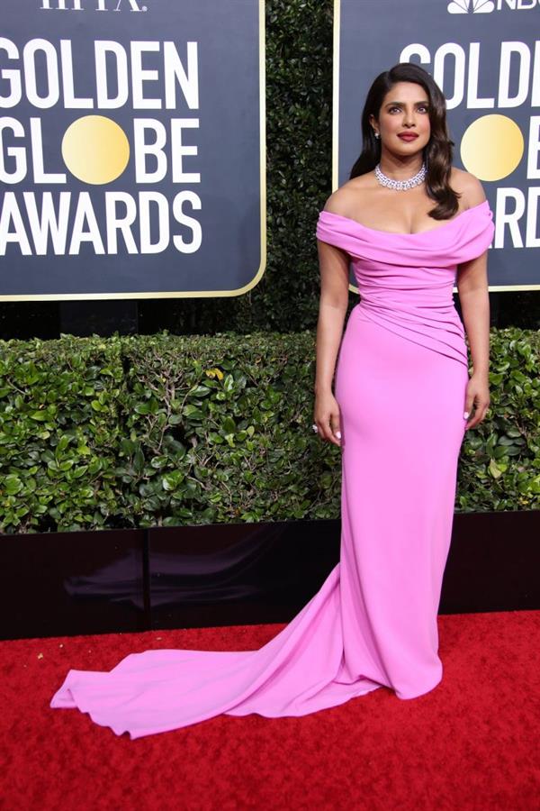 Priyanka Chopra showing nice cleavage with her big tits in a sexy pink dress arriving to the Golden Globe Awards.