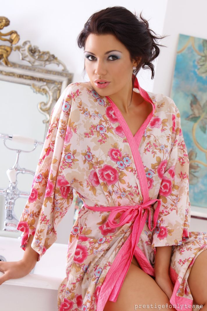  Beautiful brunette teases her way out of her dressing gown and slips into the bath. 