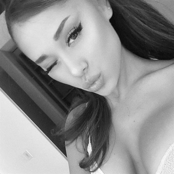 Ariana Grande boobs showing nice cleavage with her tits in a sexy white bra closeup in a new black and white photo.