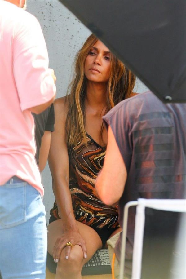 Halle Berry braless boobs in a see through minidress showing off her big tits clearly showing her nipple and panties with an Upskirt during a photoshoot.