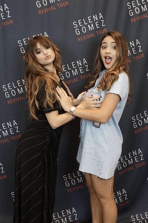 Selena Gomez and a fan at a meet and greet grabbing each others boobs photo.