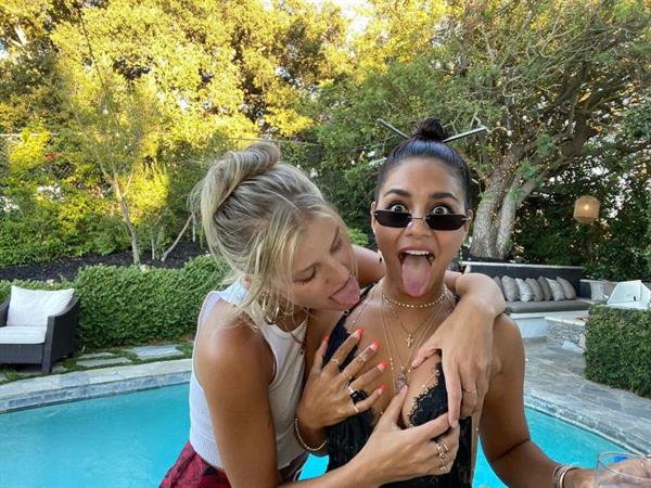 Vanessa Hudgens showing nice cleavage with her friend grabbing her big tits with both with their tongues out.