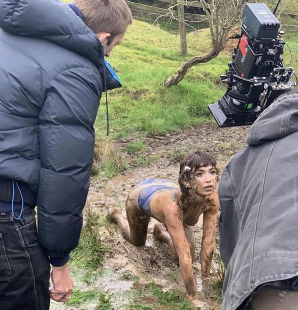 Rowan Blanchard nude boobs behind the scenes photo showing her crawling through the mud outside showing her topless tits.