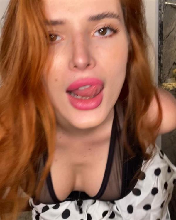 Bella Thorne boobs showing nice cleavage with her big tits and sexy ass in a hot see through black thong lingerie bodysuit.