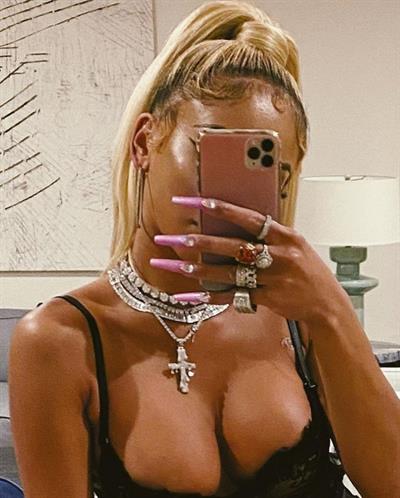 Saweetie boobs showing nice cleavage with her big tits and sexy ass booty in a hot black see through dress.