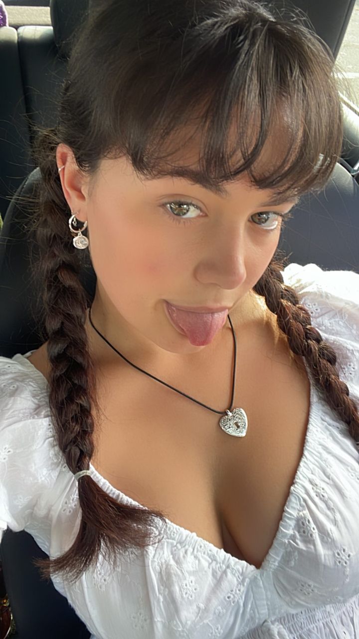 Rebekah Liepa taking a selfie in a low-cut blouse.