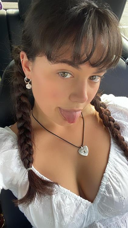 Rebekah Liepa taking a selfie in a low-cut blouse.