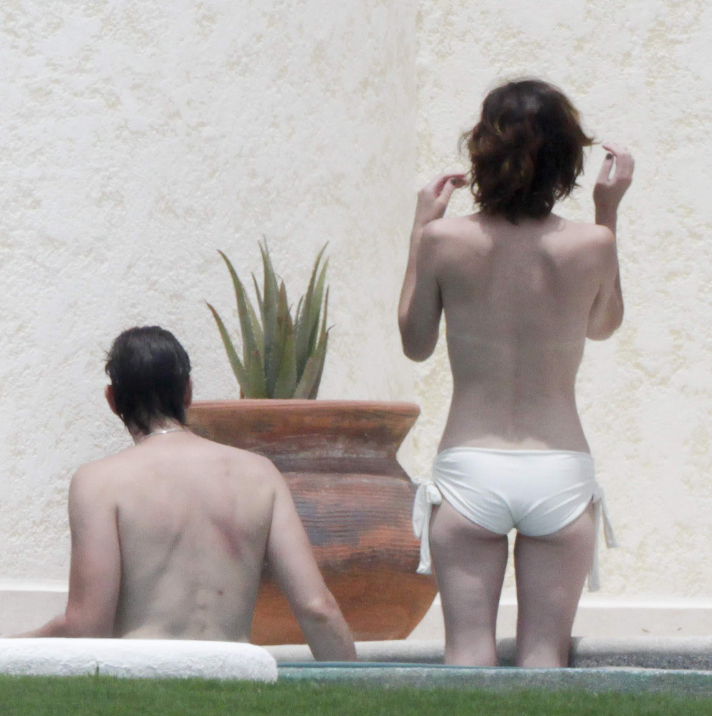 Milla Jovovich in a bikini - ass
