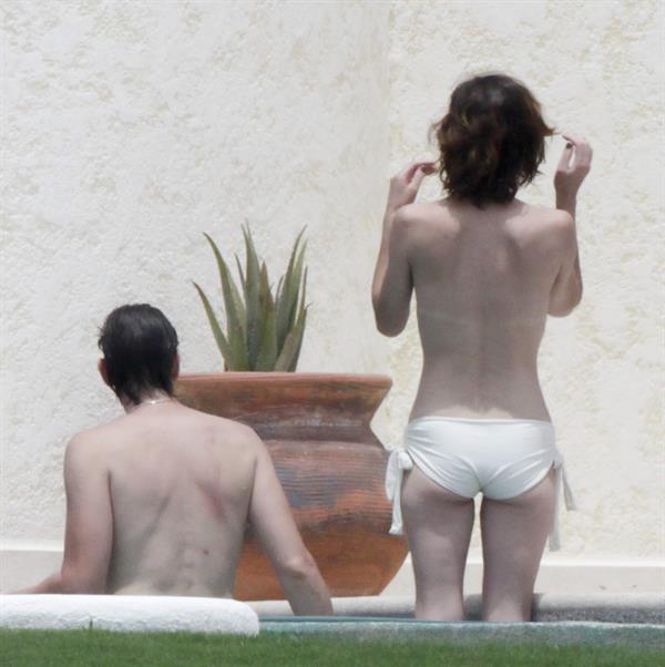 Milla Jovovich in a bikini - ass