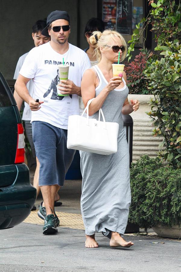 Pamela Anderson leaves barefoot a local Restaurant with a friend in Malibu July 6, 2013 